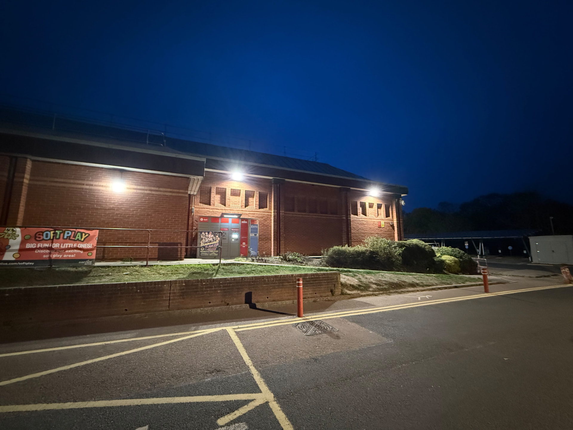 external LED wall lighting on a leisure centre at night, lights along the main building
